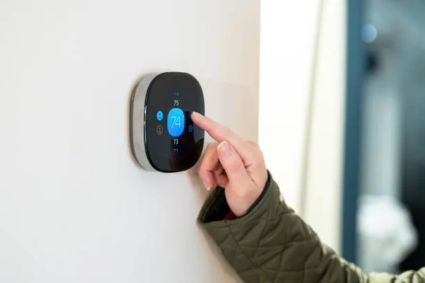 Smart thermostat mounted on a wall in a modern GTA home