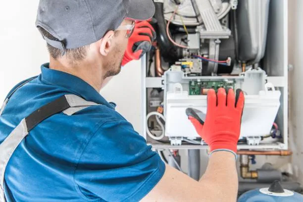 Technician evaluating a 15-year-old furnace in a Toronto basement