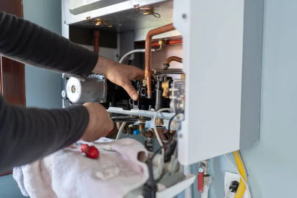 Water heater being inspected for repair or replacement in a GTA home
